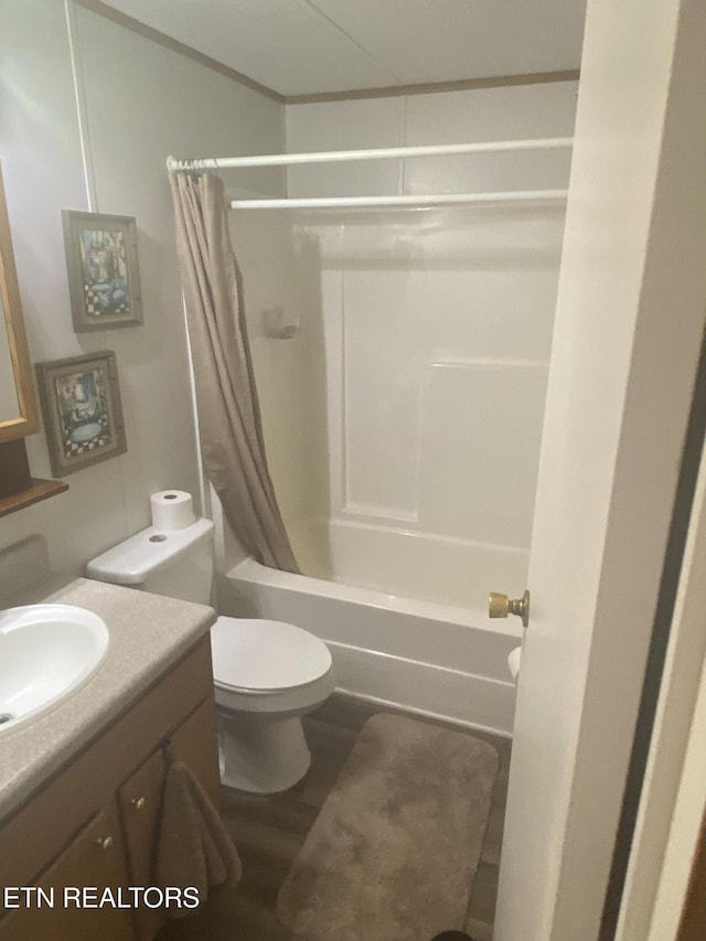 full bathroom with toilet, shower / tub combo, wood finished floors, and vanity