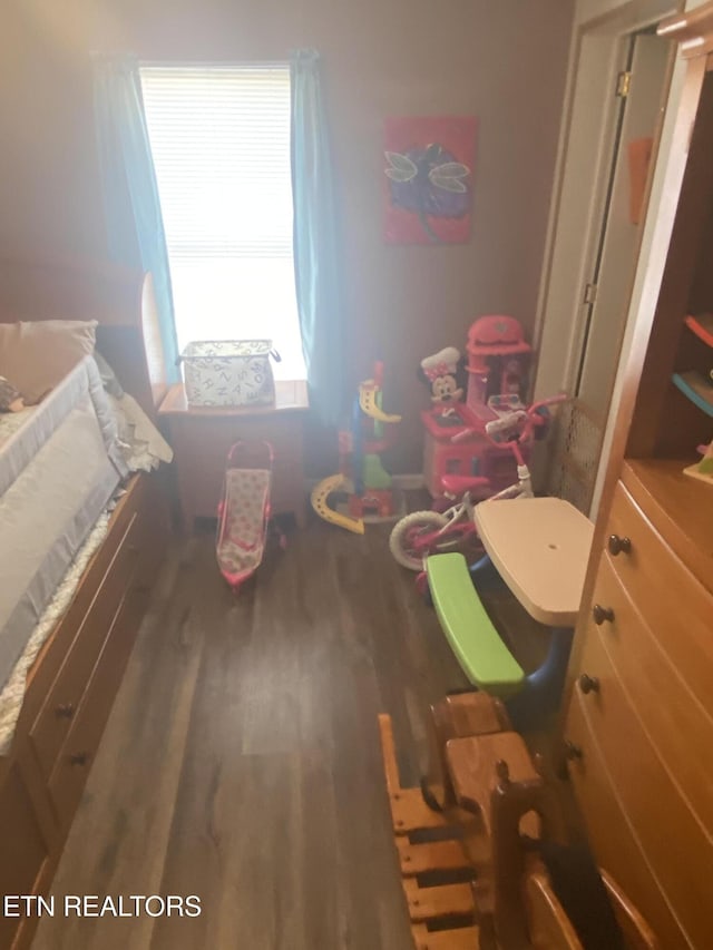 bedroom with dark wood-style flooring