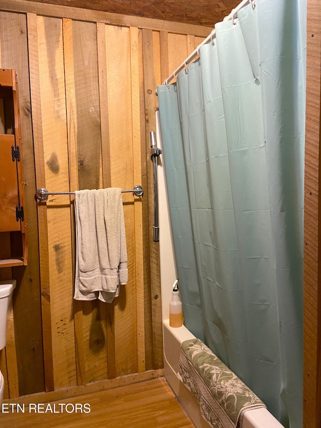 full bath featuring toilet and wood finished floors