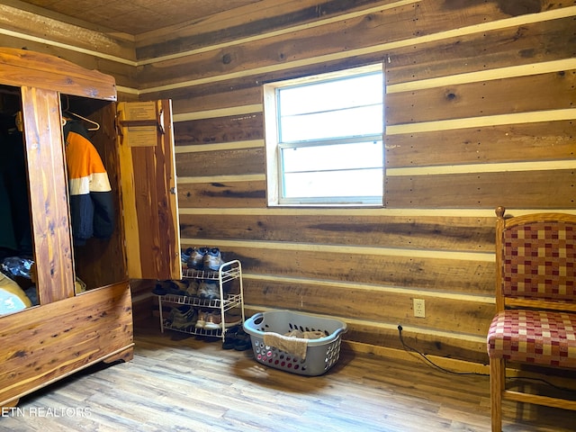 interior space with wood walls and wood finished floors