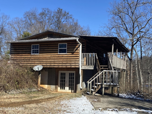 view of front of property with french doors and stairway