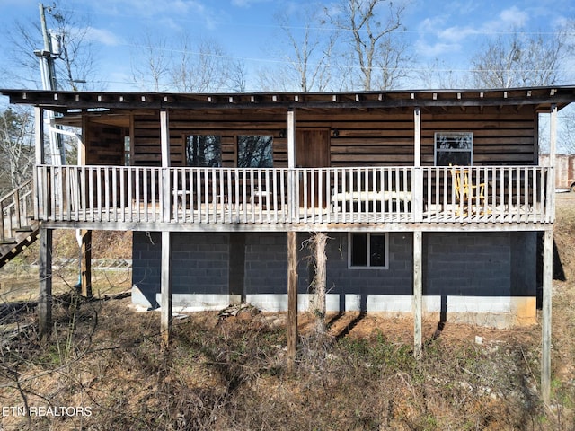 rear view of house featuring a wooden deck