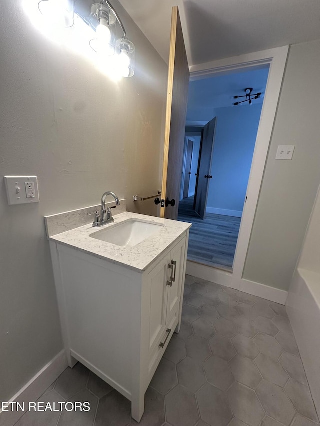 bathroom featuring vanity, baseboards, and tile patterned floors