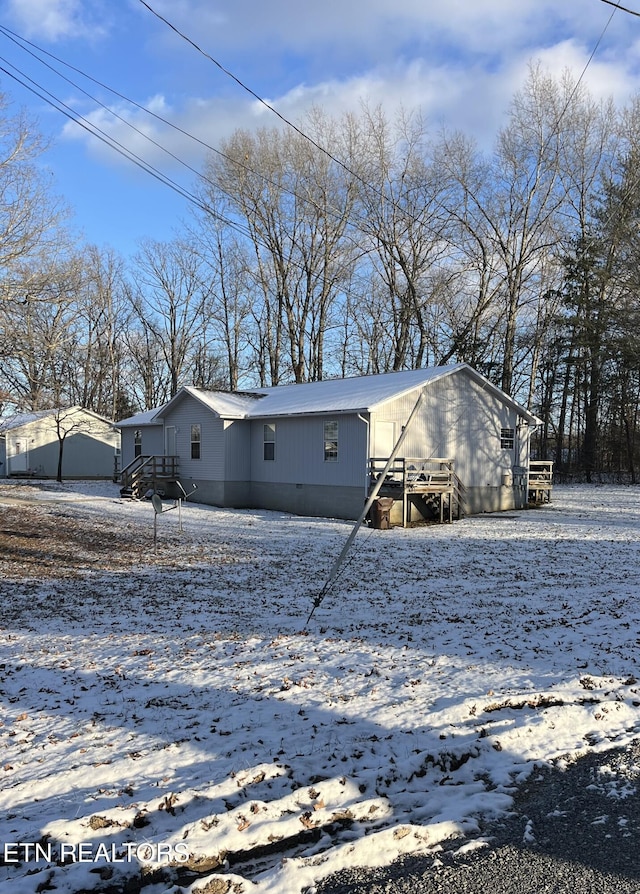 view of snow covered house