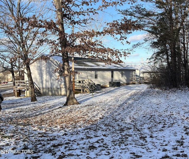 view of snow covered rear of property