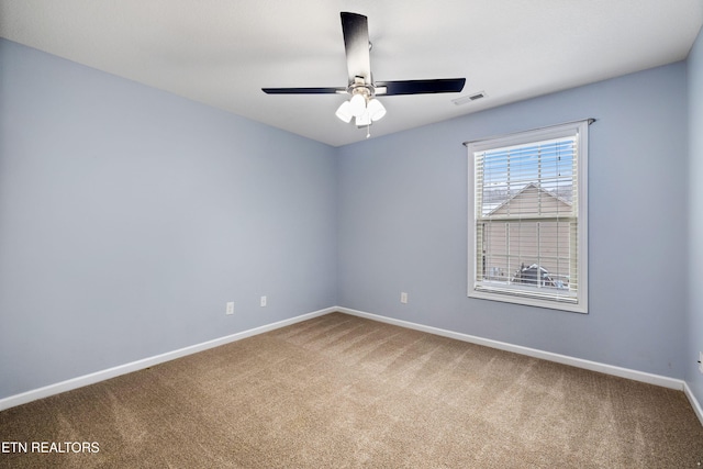 unfurnished room featuring ceiling fan, carpet floors, visible vents, and baseboards