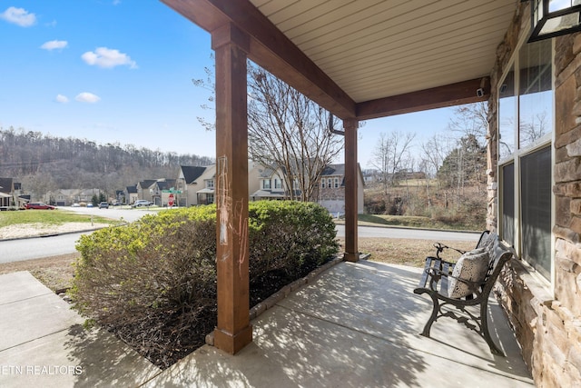 view of patio featuring covered porch and a residential view