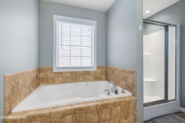 full bath featuring a garden tub and a stall shower