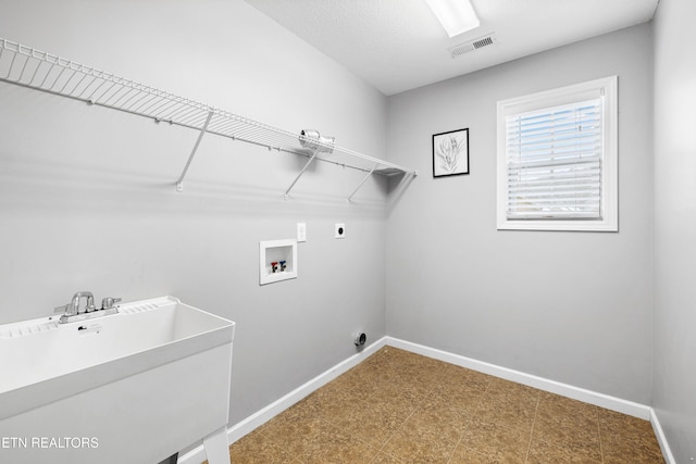 laundry room with laundry area, baseboards, visible vents, hookup for a washing machine, and electric dryer hookup