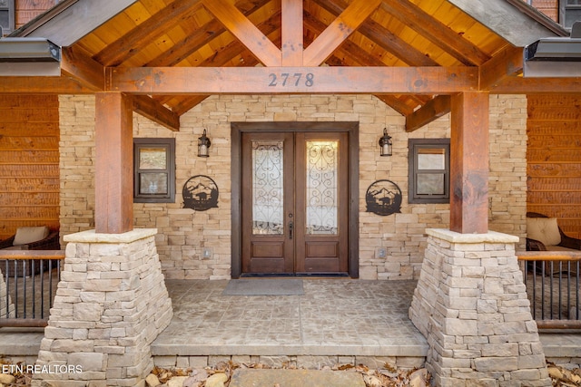 doorway to property featuring stone siding