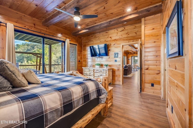 bedroom with beam ceiling, light wood-style flooring, wood walls, access to outside, and wooden ceiling