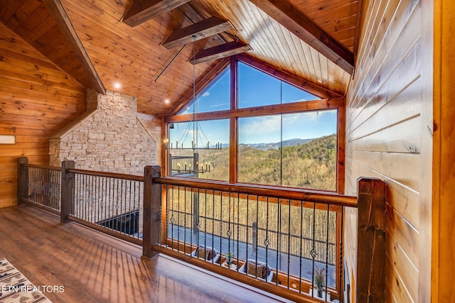 additional living space featuring beam ceiling, wood ceiling, wood walls, wood finished floors, and high vaulted ceiling