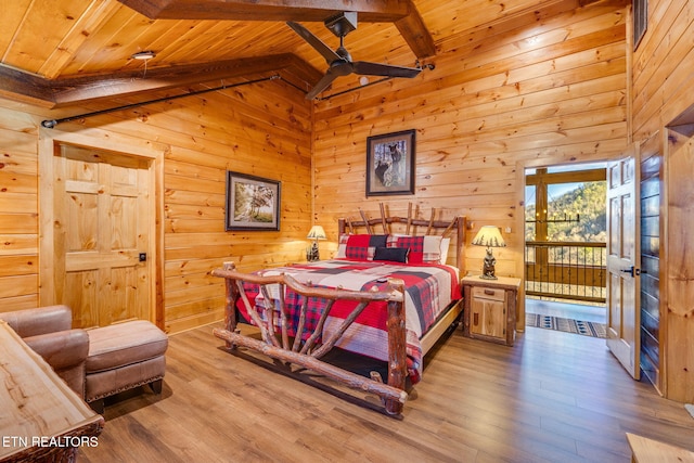 bedroom featuring wood ceiling, wood finished floors, wood walls, high vaulted ceiling, and beam ceiling