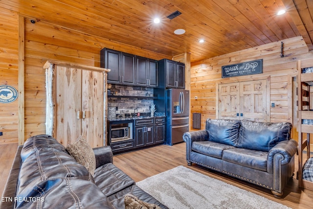 living area featuring recessed lighting, wood ceiling, wooden walls, and light wood finished floors