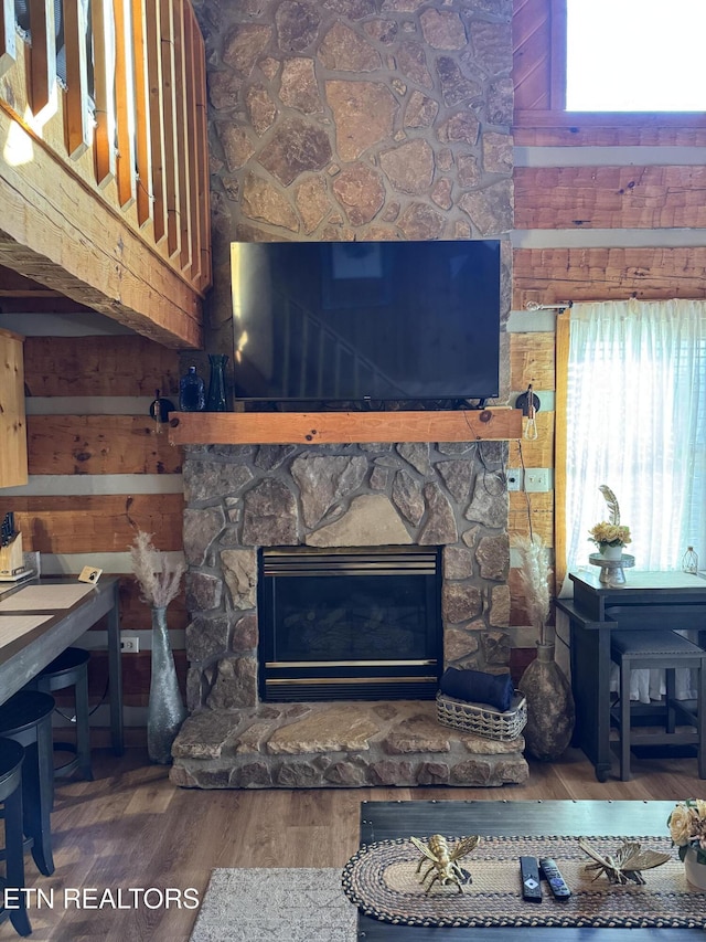 interior details featuring a fireplace and wood finished floors