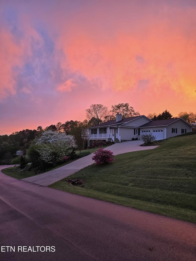 353 Southshore Dr, Greenback, TN 37742 - ranch-style house featuring concrete driveway, a front yard, an attached garage, and a chimney