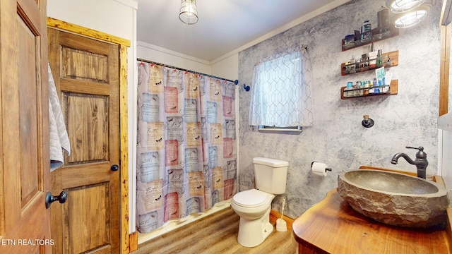 full bathroom with a shower with shower curtain, toilet, ornamental molding, vanity, and wood finished floors