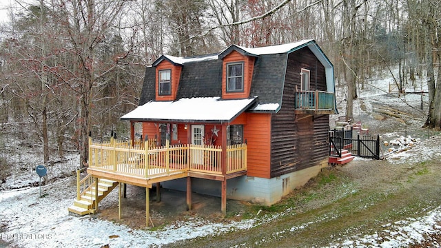 view of front of property with crawl space, a shingled roof, stairs, and a gambrel roof