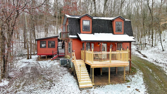 exterior space featuring a shingled roof, stairs, central AC unit, and a gambrel roof