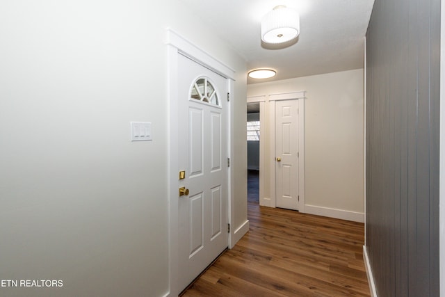 entryway featuring baseboards and wood finished floors