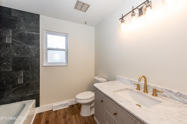 full bath featuring toilet, visible vents, wood finished floors, and vanity