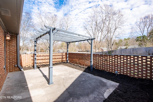 view of patio with fence, visible vents, and a pergola