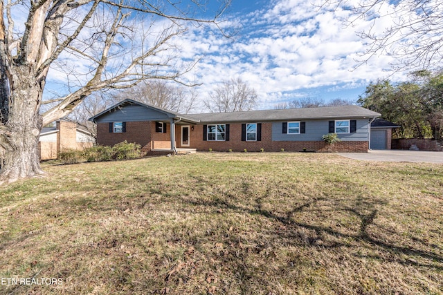 ranch-style house featuring a garage, driveway, brick siding, and a front yard