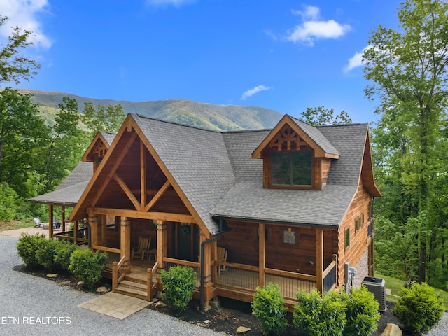 3859 Clabo Mountain Ln, Sevierville, TN 37862 - view of front of home with covered porch, central air condition unit, a mountain view, and a shingled roof