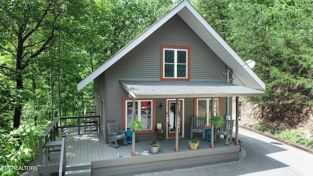 view of front of house with a porch and a shingled roof