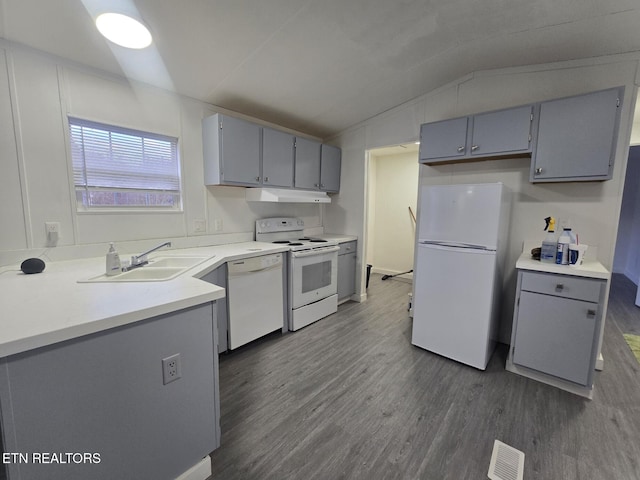 kitchen with light countertops, white appliances, a sink, and gray cabinetry