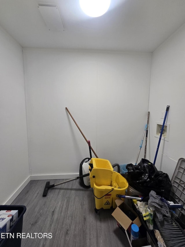 interior space featuring dark wood-type flooring and baseboards