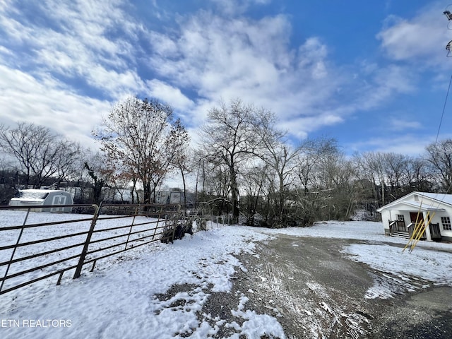 snowy yard with fence