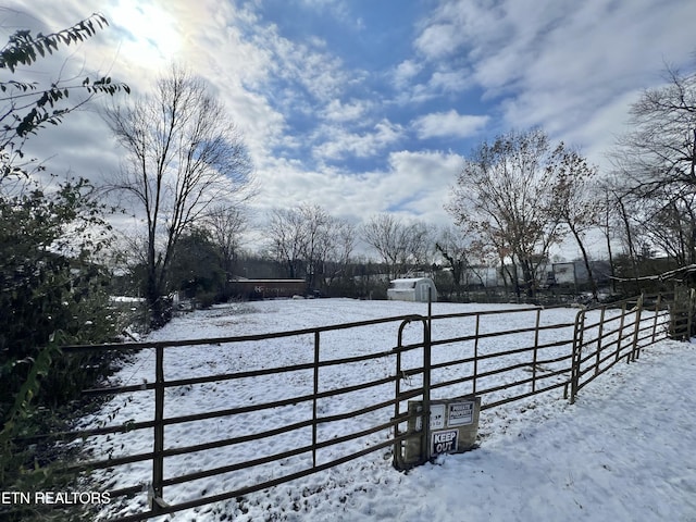 snowy yard featuring fence