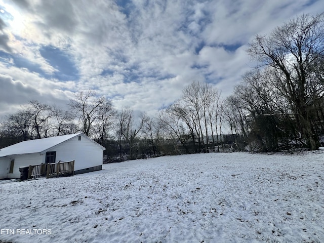 snowy yard with a deck