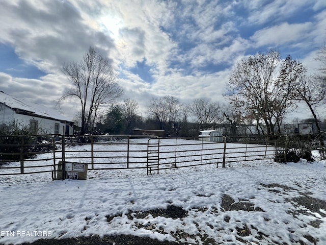 yard covered in snow featuring fence