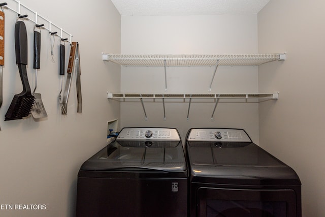 washroom featuring washing machine and dryer and laundry area