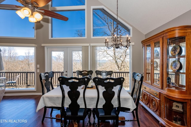 dining area featuring dark wood-type flooring, french doors, a notable chandelier, and high vaulted ceiling