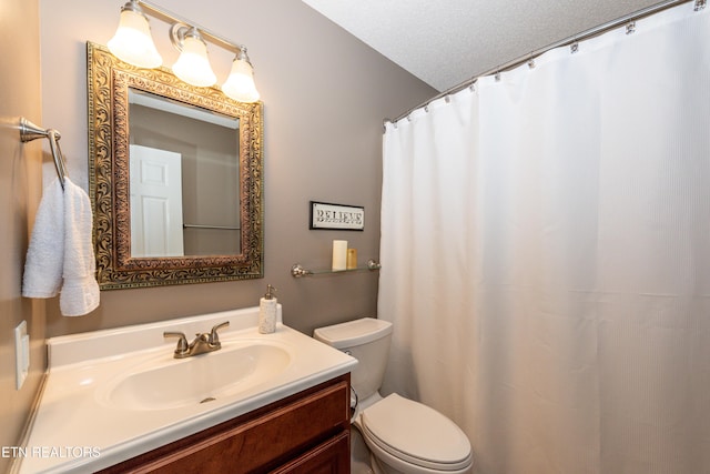 bathroom featuring a textured ceiling, vanity, toilet, and a shower with curtain