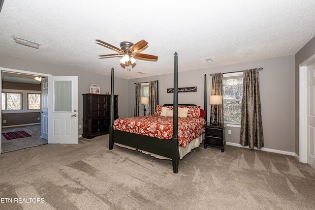 bedroom featuring a textured ceiling, multiple windows, carpet, and visible vents