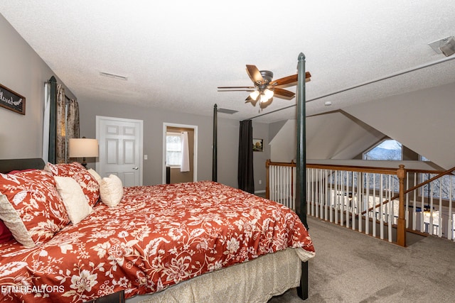 bedroom with carpet, visible vents, ceiling fan, and a textured ceiling