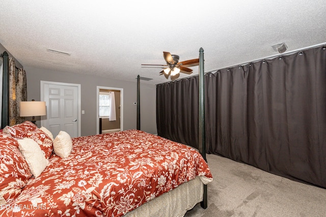 bedroom featuring carpet floors, a ceiling fan, visible vents, and a textured ceiling