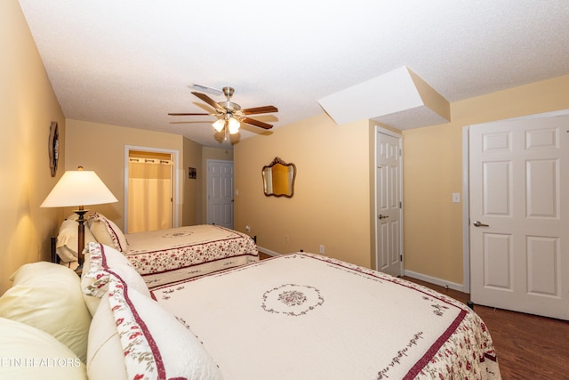 bedroom with ceiling fan, dark wood-type flooring, and baseboards