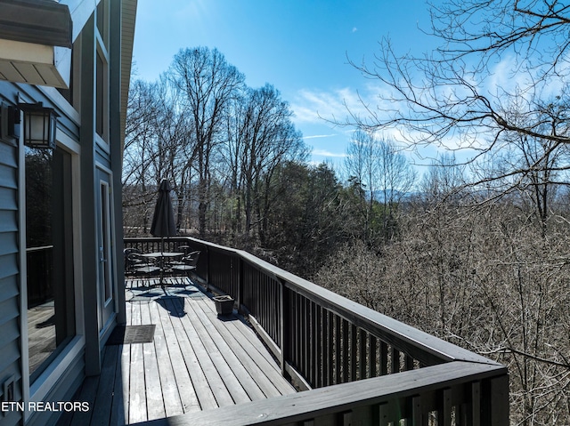 wooden deck featuring outdoor dining area