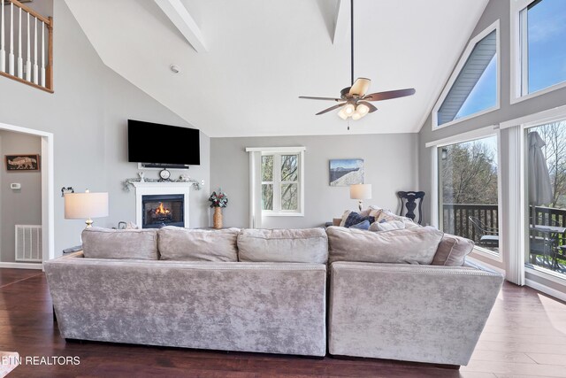 2201 Applewood Rd, Pigeon Forge, TN 37862 - living area featuring dark wood finished floors, a warm lit fireplace, visible vents, and a ceiling fan