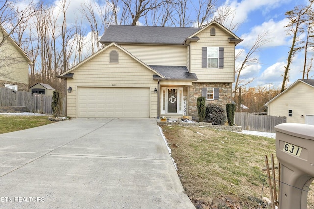 traditional home featuring a garage, concrete driveway, stone siding, fence, and a front yard