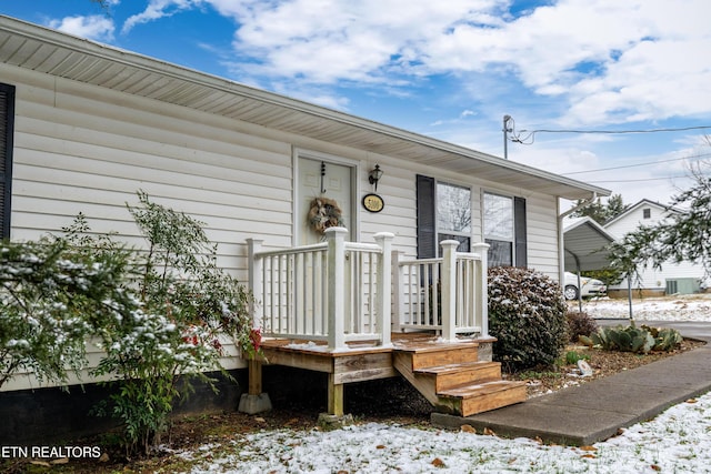 view of snow covered property entrance