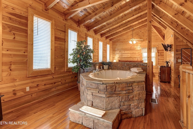 bathroom with wood ceiling, wood walls, lofted ceiling with beams, and wood finished floors