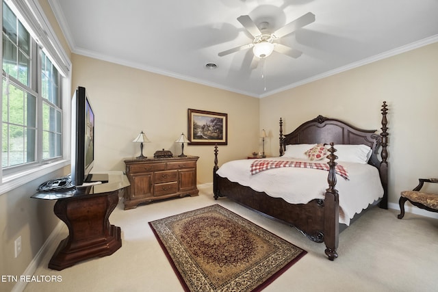 bedroom with light carpet, a ceiling fan, baseboards, visible vents, and crown molding