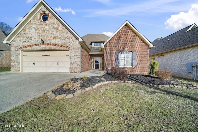 view of front of home featuring a garage, driveway, brick siding, stone siding, and a front yard