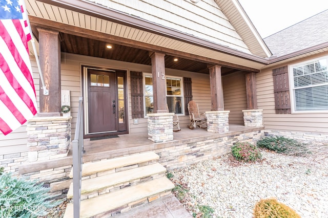 view of exterior entry with covered porch